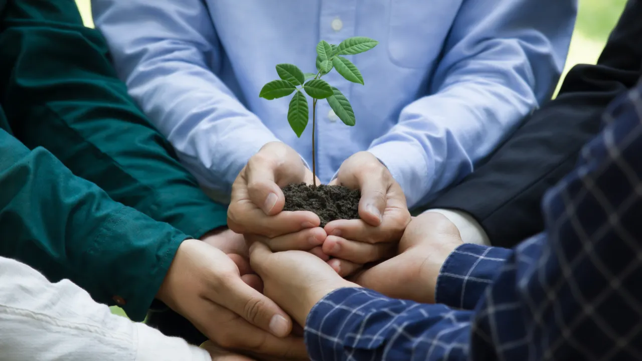 Two people shaking hands over a partnership agreement